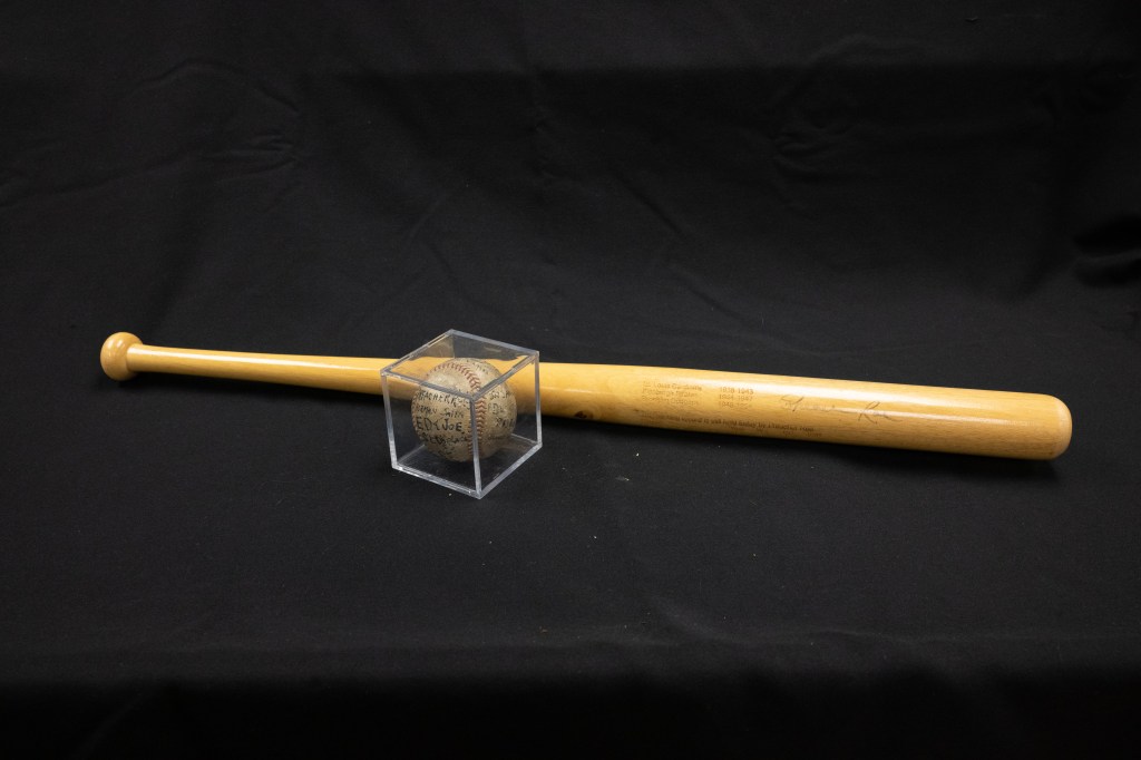 Photo of a baseball bat and ball signed by Preacher Roe.