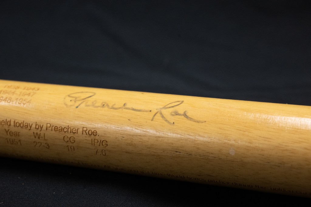 Photo of a baseball bat signed by Preacher Roe.